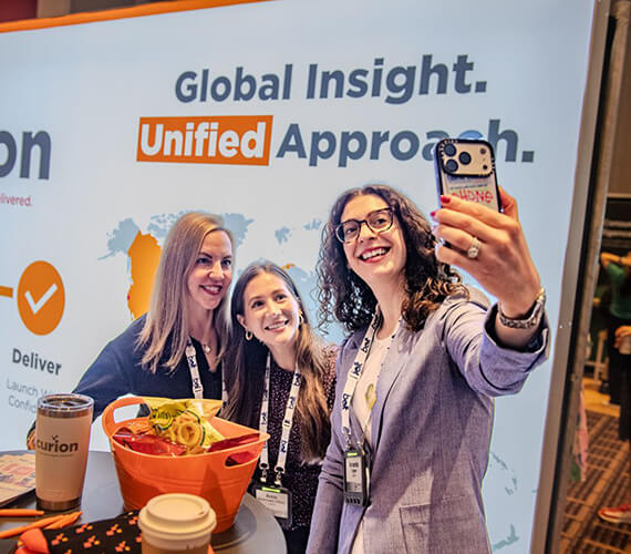 Group of coworkers in a company event and main person taking the selfie.